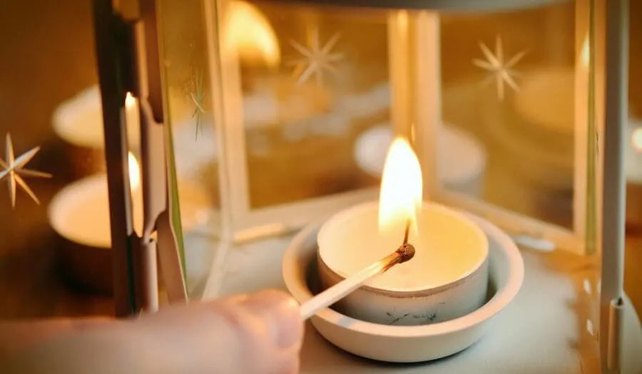 lighting a candle in a lantern