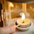 lighting a candle in a lantern